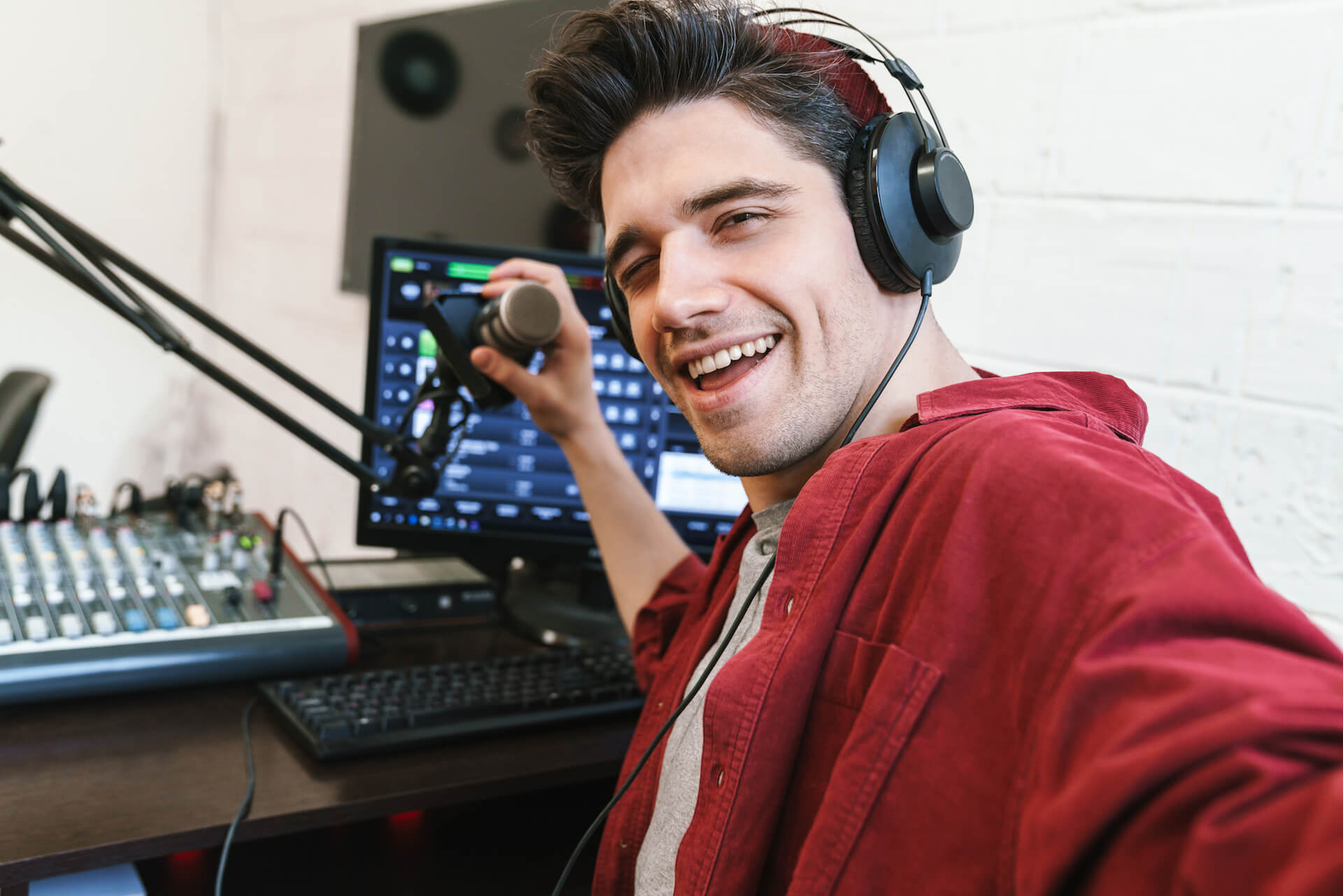 image-of-young-happy-dj-man-wearing-headphones-wor-2021-08-30-02-26-03-utc.jpg